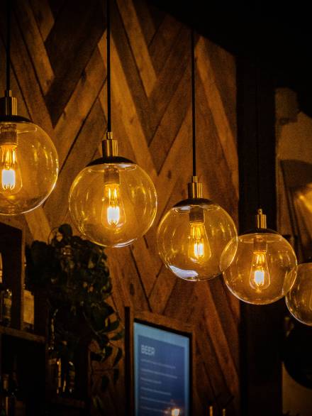 A row of decorative light bulbs hanging in a cafe