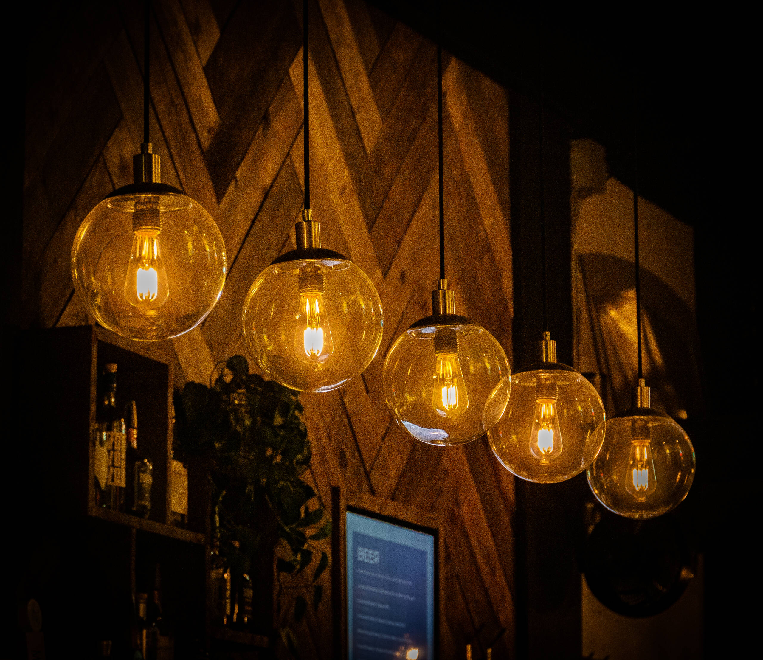 A row of decorative light bulbs hanging in a cafe